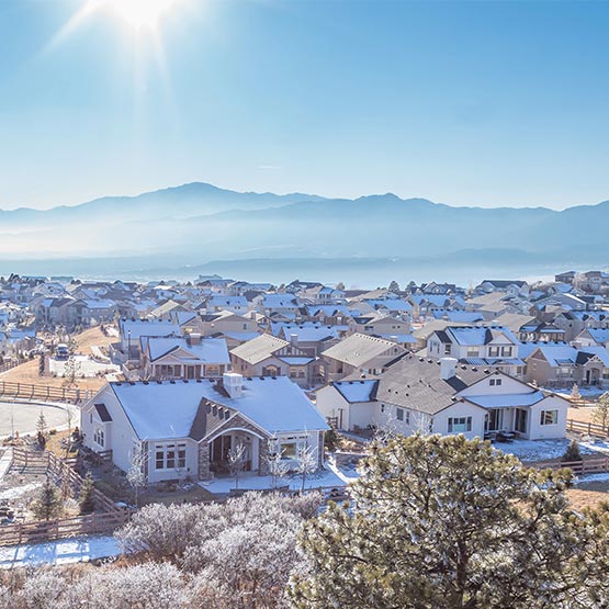 promo_home_2_sq Daytime view of houses on the front range with the mountains in the background