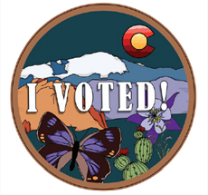 circle graphic image of pikes peak in the background and a representation of garden of the gods with a cactus a butterfly and a columbine and the colorado flag c and o representing the sun in the sky and text overlay reading i voted