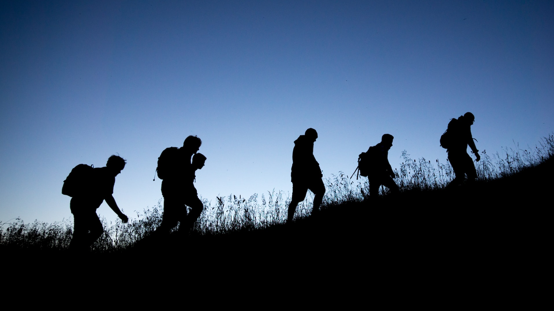 Group of people hiking at night cropped